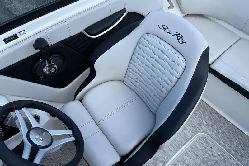 Slide: The Image of 2023 Sea Ray SPX 190 boat interior with steering wheel and branded seat. - 6