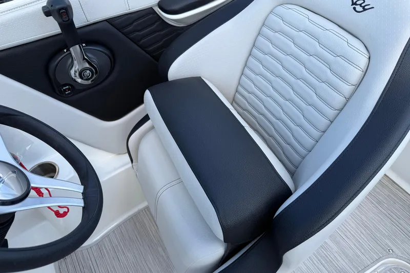 Slide: The Image of 2023 Sea Ray SPX 190 boat interior with steering wheel and comfortable seating. - 7