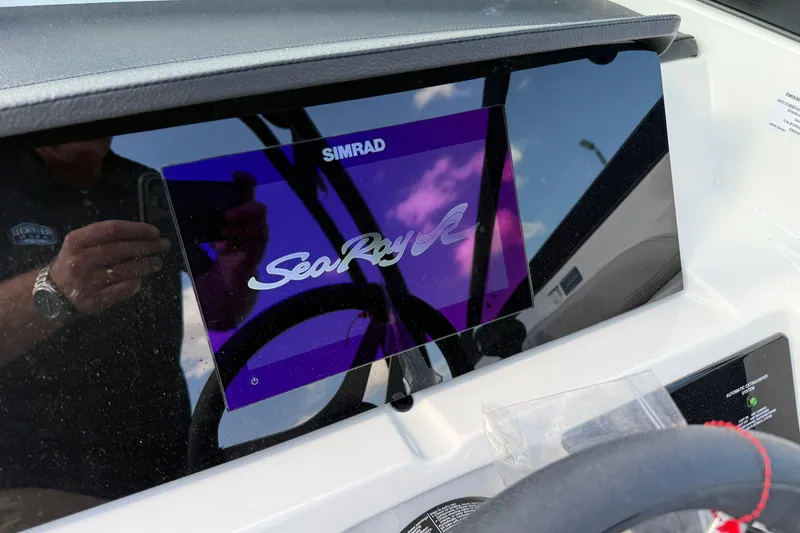 Slide: The Image of Simrad display on 2023 Sea Ray SPX 190 boat dashboard, reflecting sky and surroundings. - 30