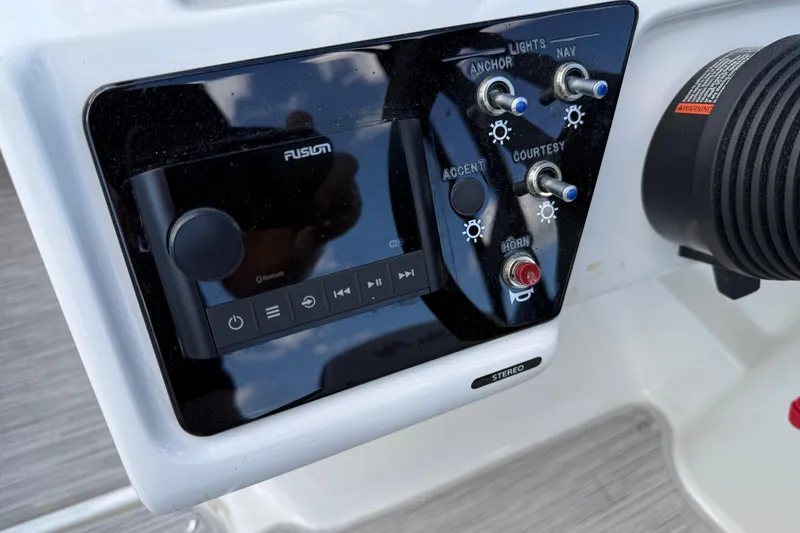 Slide: The Image of Control panel of 2023 Sea Ray SPX 190 boat with stereo and switches. - 16