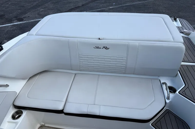 Slide: The Image of 2023 Sea Ray SPX 190 boat with white cushioned seating and sleek design. - 9