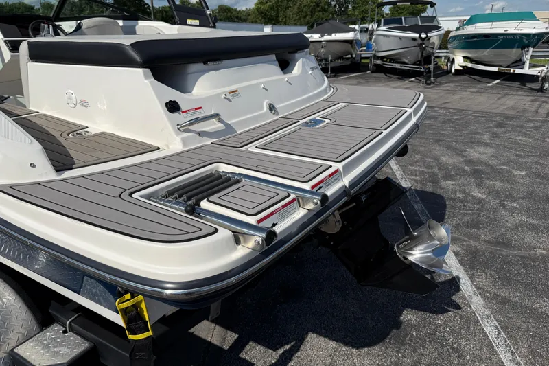 Slide: The Image of 2023 Sea Ray SPX 190 boat with swim platform and ladder, displayed outdoors. - 5