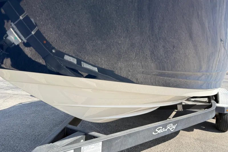 Slide: The Image of 2023 Sea Ray SPX 190 boat on trailer, showcasing sleek hull design. - 26