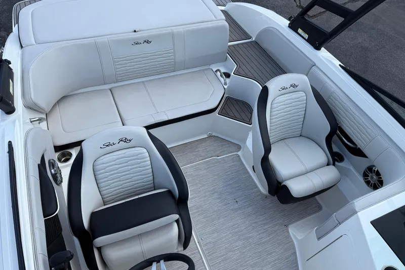 Slide: The Image of 2023 Sea Ray SPX 190 boat interior with white leather seating and modern design. - 8