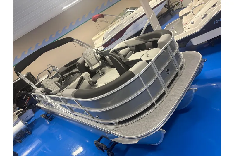 Slide: The Image of 2026 South Bay S224RS pontoon boat with sleek design in showroom setting. - 2
