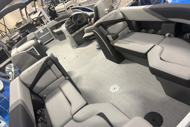 Slide: The Image of 2026 South Bay S224RS pontoon boat interior with luxurious seating and modern dashboard. - 8