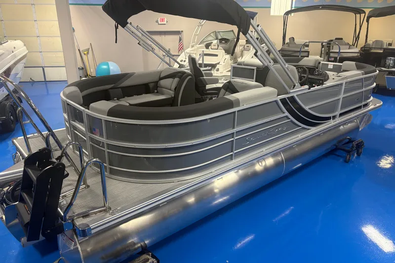 The Image of 2026 South Bay S224RS pontoon boat with sleek design in showroom setting. - 0