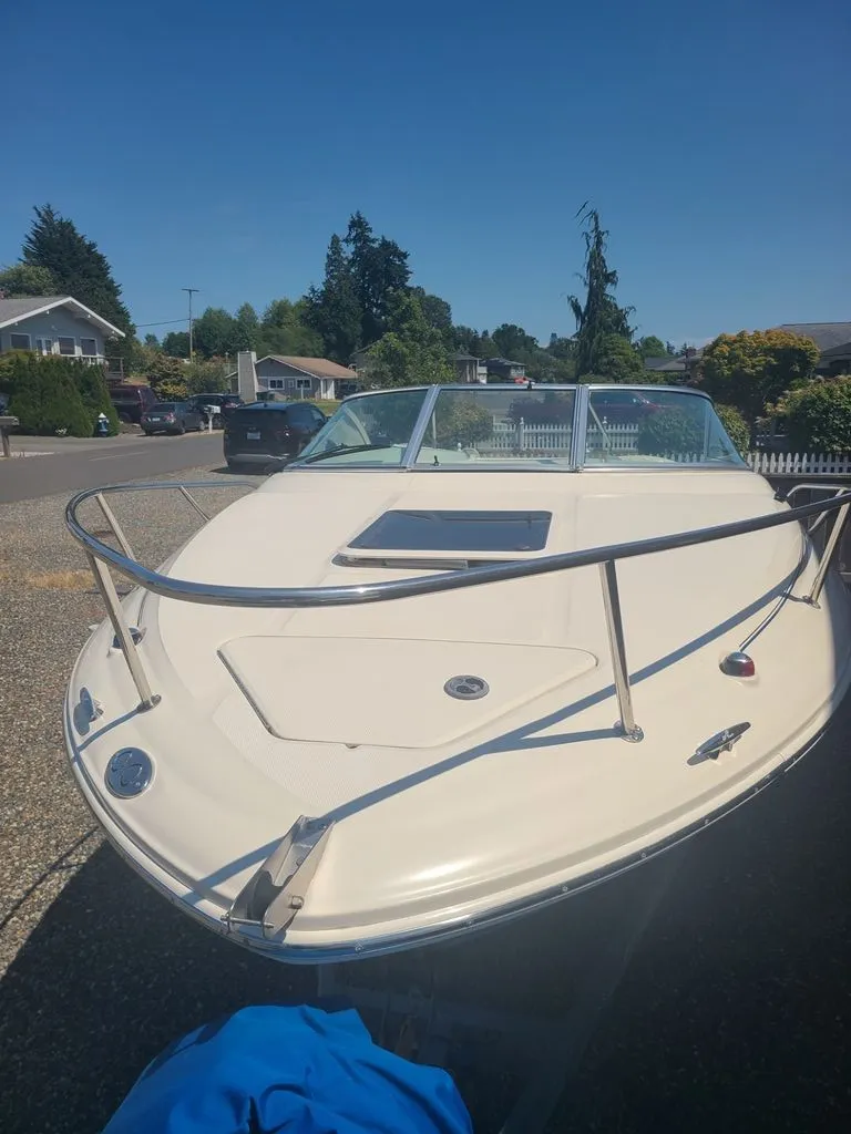 Slide: The Image of A 2002 Sea Ray 225 Weekender is on a trailer in a residential area. - 3