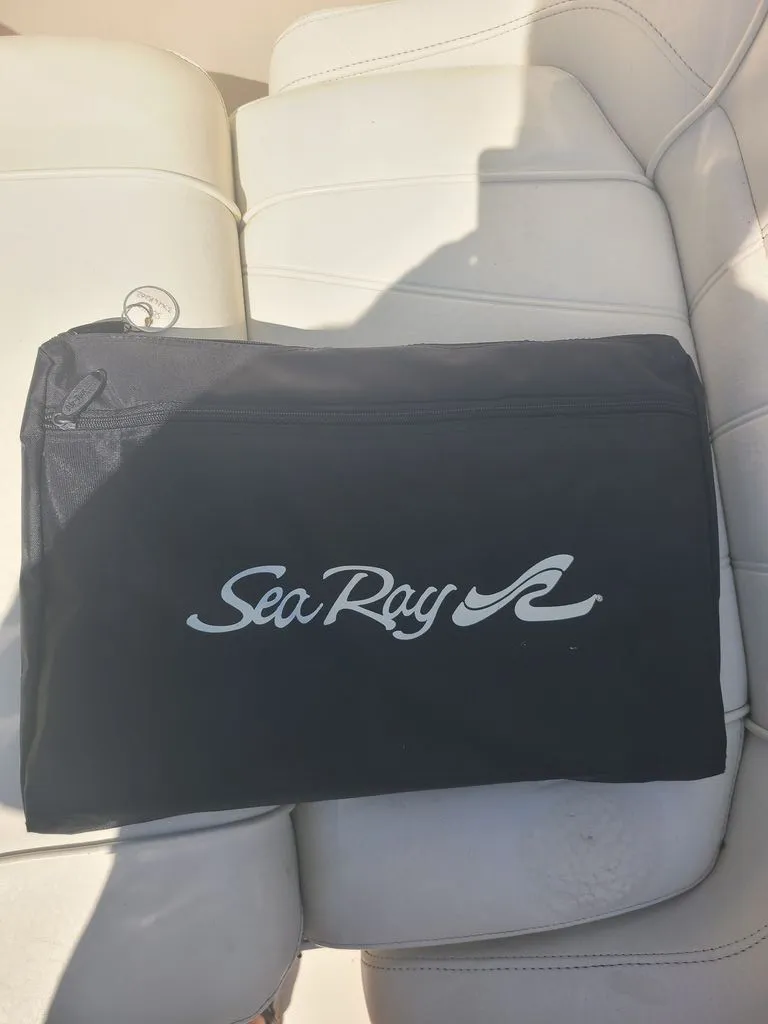 Slide: The Image of A black Sea Ray bag rests on a white boat seat. - 4
