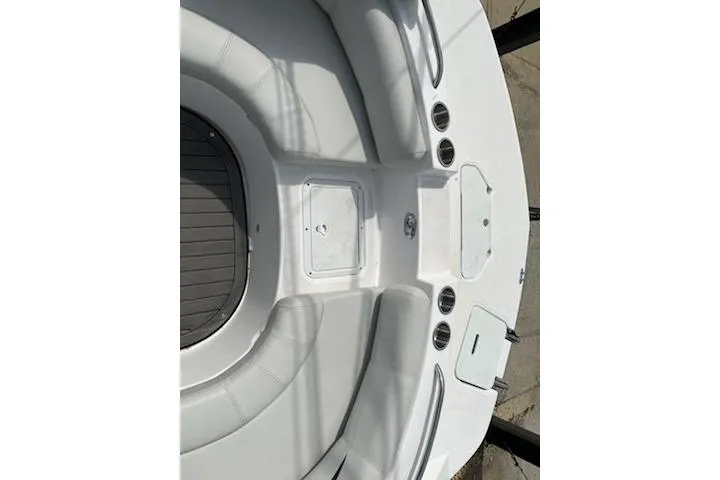 Slide: The Image of 2022 Hurricane SunDeck Sport 188 IO boat interior with white seating and storage compartments. - 14