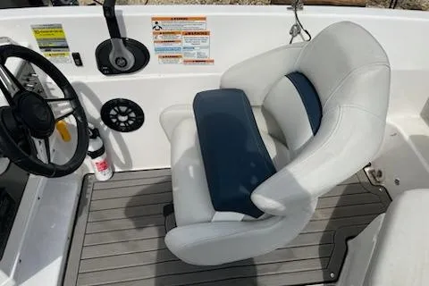 Slide: The Image of 2022 Hurricane SunDeck Sport 188 IO boat interior with steering wheel and cushioned seat. - 4