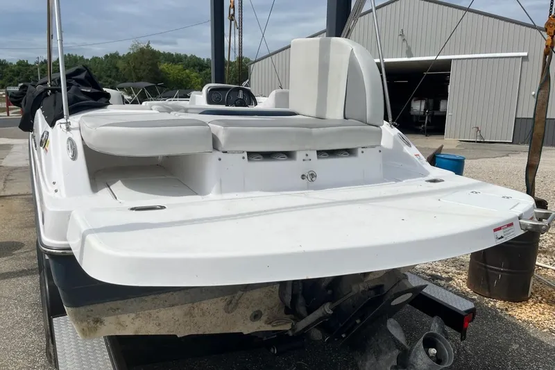 Slide: The Image of 2022 Hurricane SunDeck Sport 188 IO boat, rear view at a marina. - 17