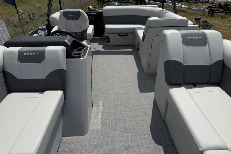 Slide: The Image of 2026 Crest Conquest SE220 Cruise pontoon boat interior with plush seating and modern design. - 3