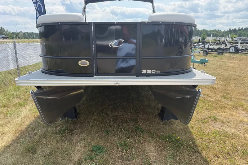 Slide: The Image of 2026 Crest Conquest SE220 Cruise pontoon boat displayed on grass under a cloudy sky. - 8