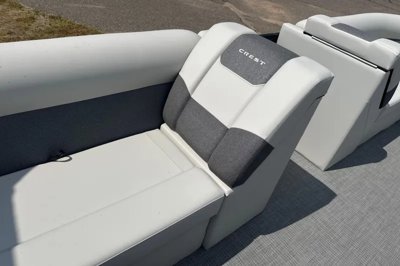 Slide: The Image of 2026 Crest Conquest SE220 Cruise boat seating with gray and white upholstery. - 1