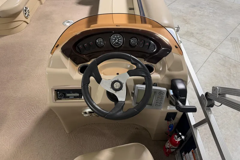 Slide: The Image of 2010 Bennington 20 SLI boat dashboard with steering wheel and control panel. - 11