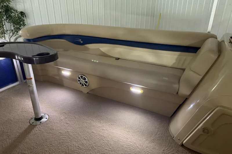 Slide: The Image of Luxurious interior of a 2010 Bennington 20 SLI pontoon boat with plush seating and table. - 3