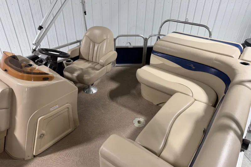 Slide: The Image of Interior of a 2010 Bennington 20 SLI pontoon boat with beige seating and steering console. - 7