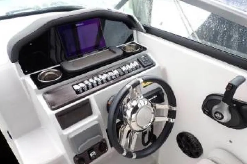 Slide: The Image of Cockpit of 2020 Rinker 270 Express Cruiser with modern steering and controls. - 8