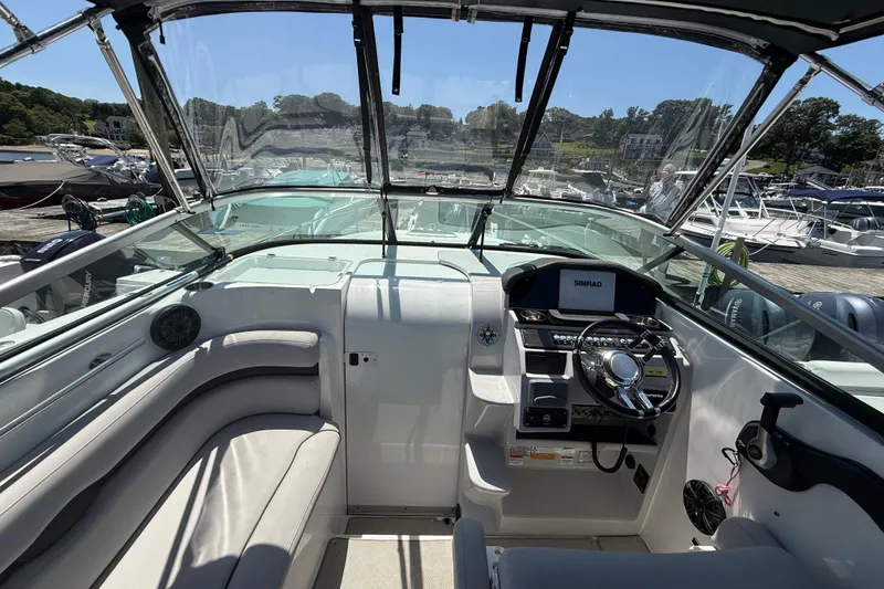 Slide: The Image of Cockpit view of 2020 Rinker 270 Express Cruiser with steering wheel and navigation system. - 13