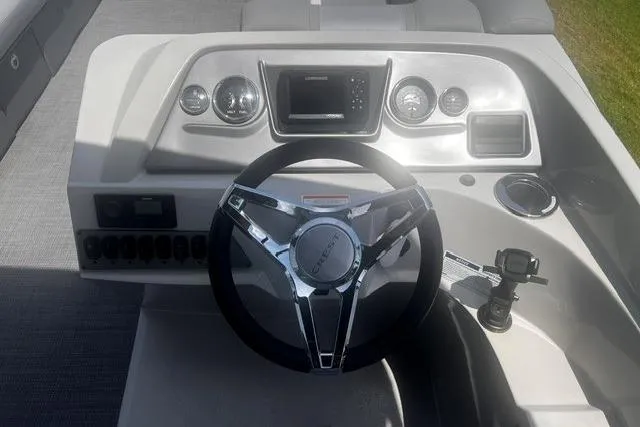 Slide: The Image of 2023 Crest Classic DLX 240 boat dashboard with steering wheel and control panel. - 9