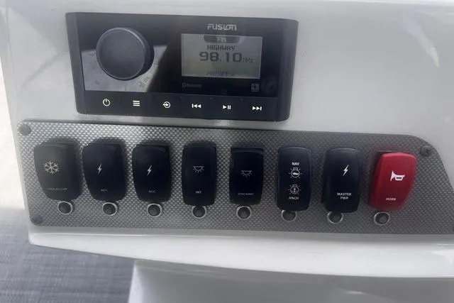 Slide: The Image of Control panel of 2023 Crest Classic DLX 240 boat with radio and switches. - 6