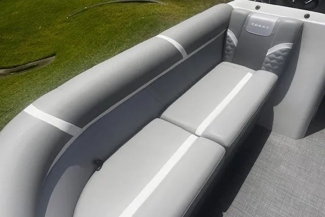 Slide: The Image of 2023 Crest Classic DLX 240 boat interior with gray seating and elegant design. - 18