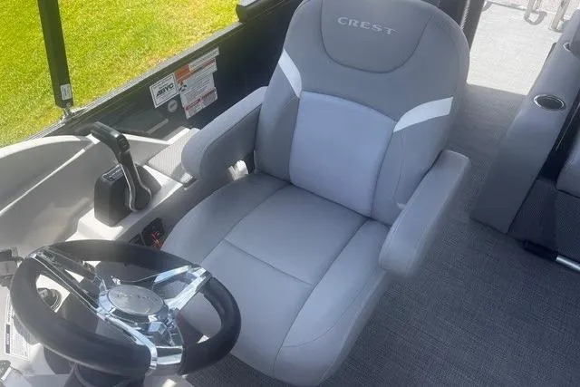 Slide: The Image of Captain's seat of 2023 Crest Classic DLX 240 boat with steering wheel. - 10