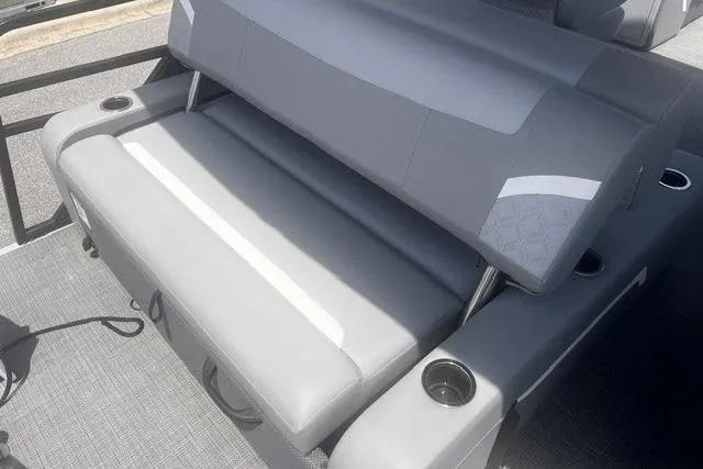Slide: The Image of 2023 Crest Classic DLX 240 boat interior with gray seating and cup holders. - 14