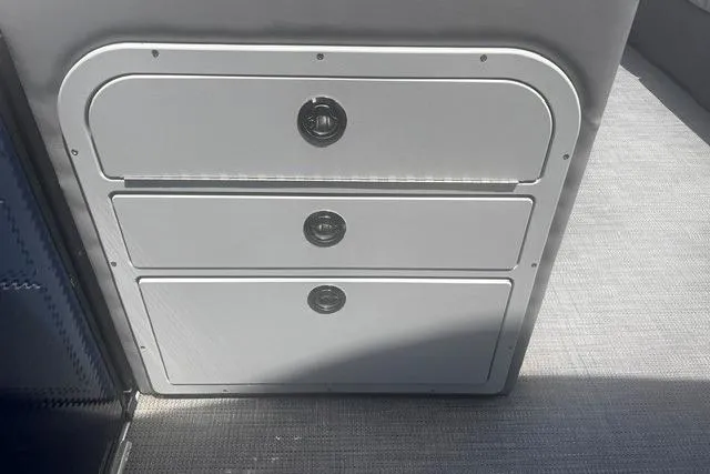 Slide: The Image of 2023 Crest Classic DLX 240 boat storage compartments with sleek design and secure latches. - 17