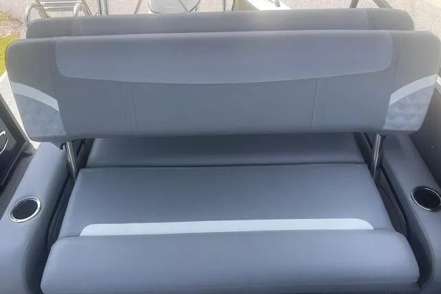 Slide: The Image of 2023 Crest Classic DLX 240 boat seating with gray upholstery and cup holders. - 12