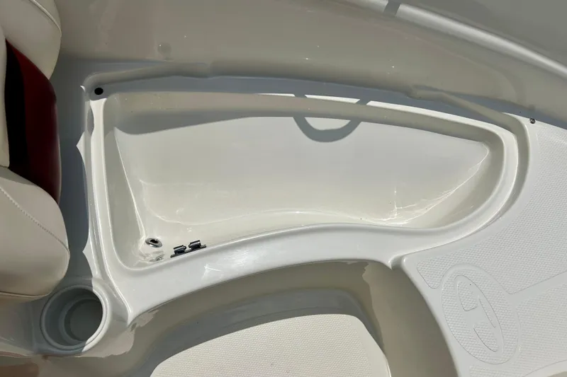 Slide: The Image of Interior view of a 2013 Tahoe Q4i boat, featuring a white storage compartment. - 8