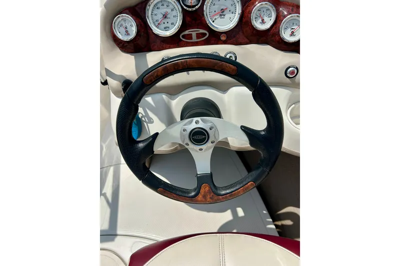 Slide: The Image of Steering wheel and dashboard of 2013 Tahoe Q4i boat with gauges and wood accents. - 28