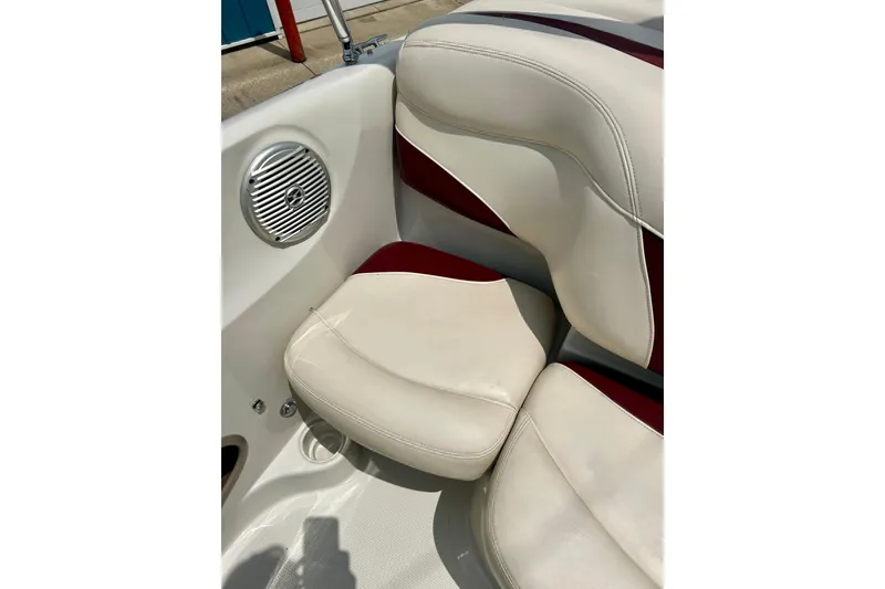 Slide: The Image of 2013 Tahoe Q4i boat interior with beige and red seating, featuring a built-in speaker. - 16