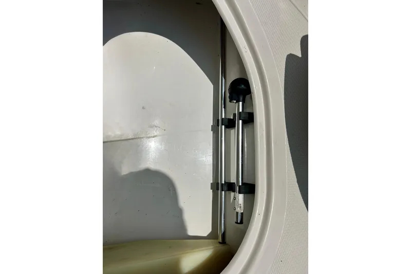 Slide: The Image of Storage compartment in a 2013 Tahoe Q4i boat, featuring a mounted rod holder. - 32