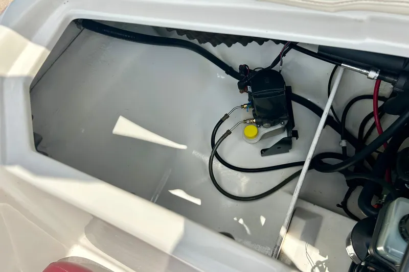 Slide: The Image of 2013 Tahoe Q4i boat compartment with visible wiring and mechanical components. - 33