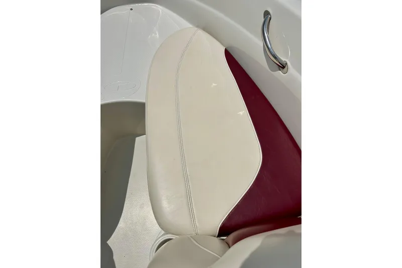 Slide: The Image of 2013 Tahoe Q4i boat seat with white and maroon upholstery, featuring a chrome handle. - 24