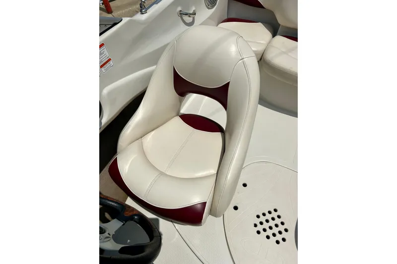 Slide: The Image of 2013 Tahoe Q4i boat interior with white and maroon seating. - 18