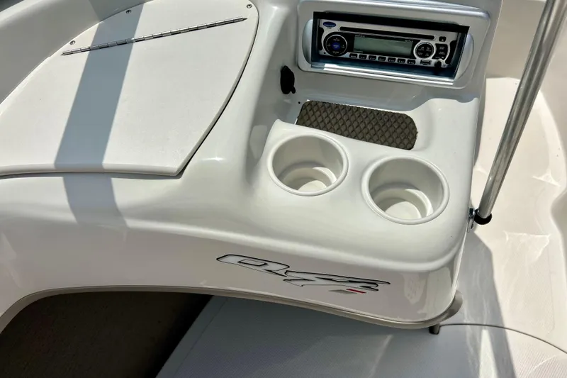 Slide: The Image of 2013 Tahoe Q4i boat interior with stereo system and cup holders. - 25