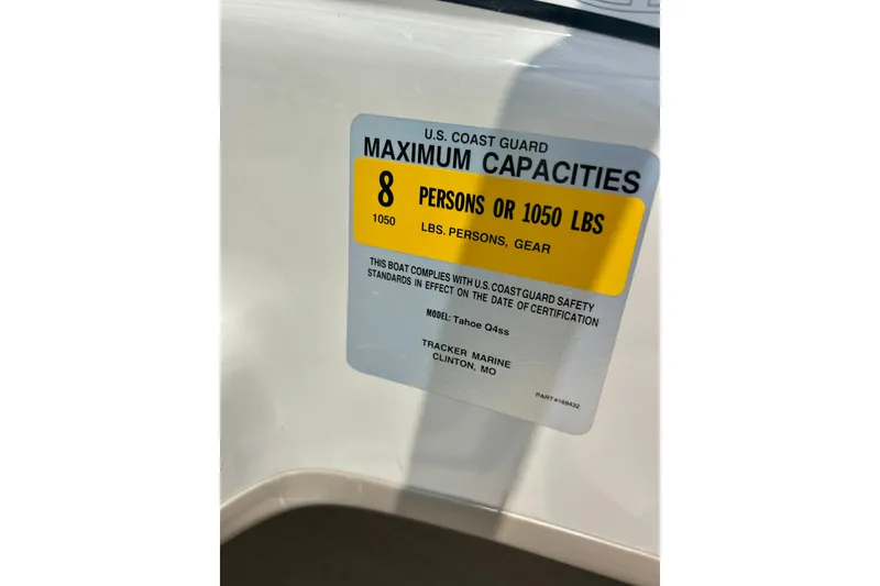 Slide: The Image of U.S. Coast Guard capacity label on 2013 Tahoe Q4i boat, 8 persons or 1050 lbs. - 15