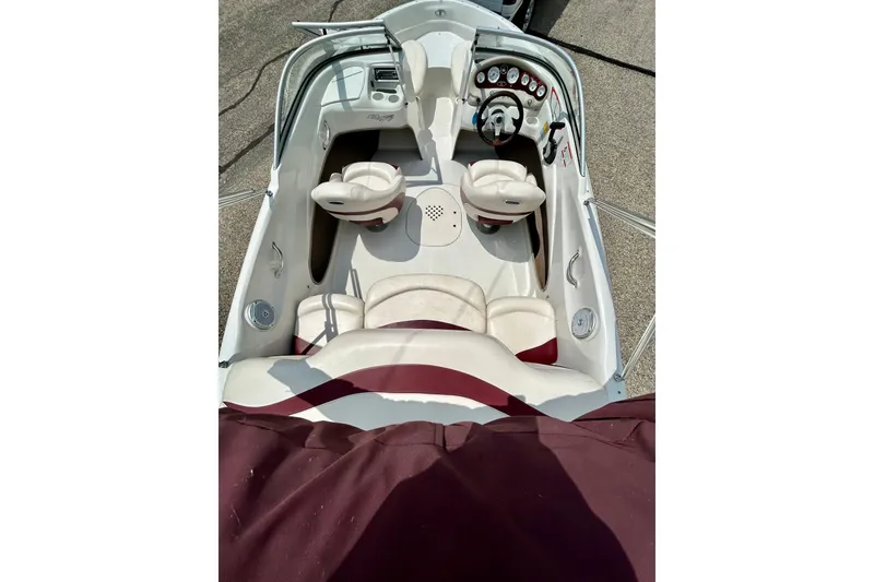 Slide: The Image of 2013 Tahoe Q4i boat interior with white and maroon seating, dashboard, and steering wheel. - 29