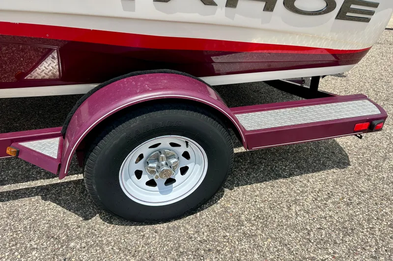 Slide: The Image of Trailer wheel and fender of a 2013 Tahoe Q4i boat on pavement. - 10