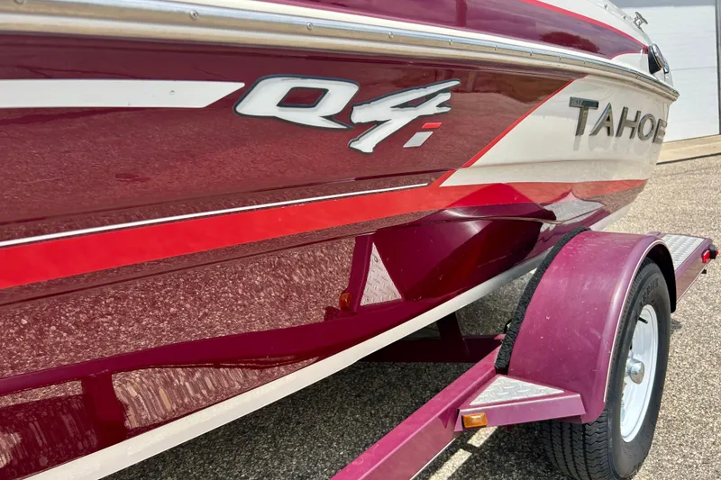Slide: The Image of Red and white 2013 Tahoe Q4i boat on a matching trailer. - 3