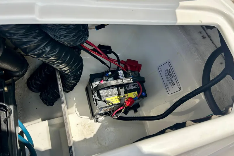 Slide: The Image of Battery compartment of a 2013 Tahoe Q4i boat with wiring and ventilation hoses. - 23