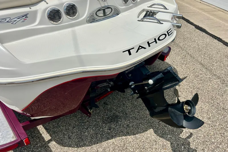 Slide: The Image of Rear view of a 2013 Tahoe Q4i boat with visible propeller and branding. - 13