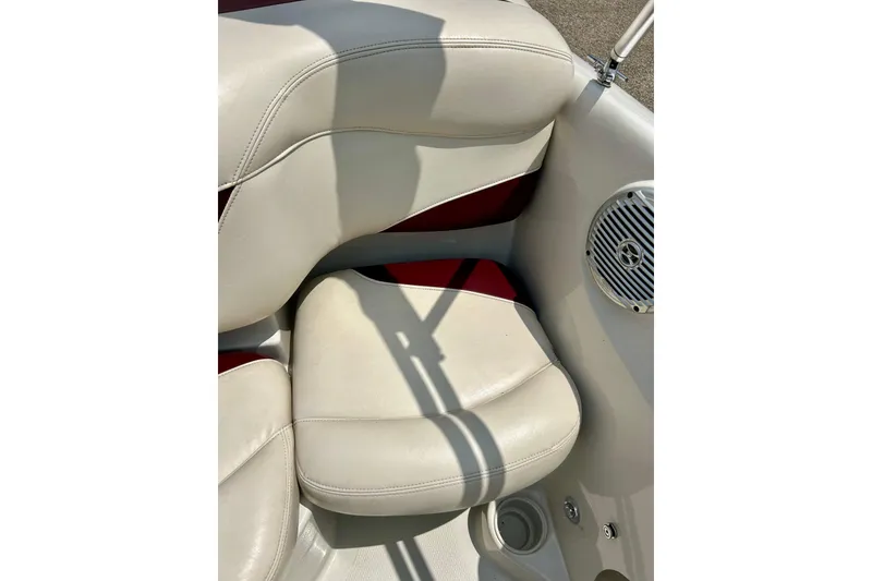 Slide: The Image of 2013 Tahoe Q4i boat interior with white and red seating and speaker detail. - 22
