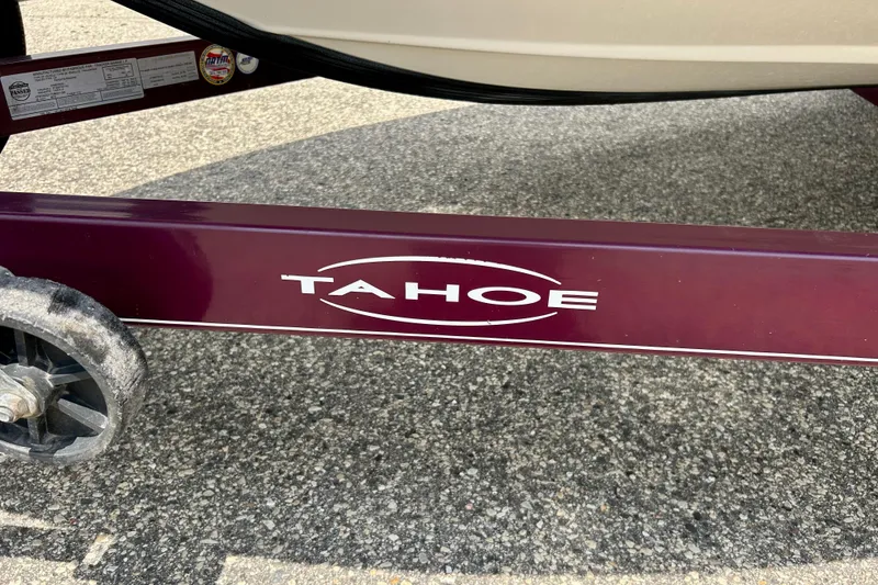 Slide: The Image of Trailer frame of a 2013 Tahoe Q4i boat with logo on pavement. - 12