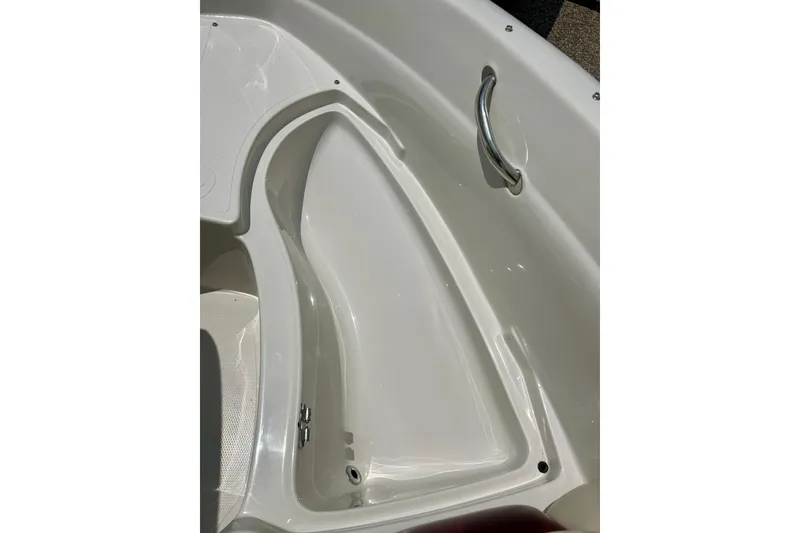 Slide: The Image of Interior view of a 2013 Tahoe Q4i boat, featuring a sleek white compartment. - 19