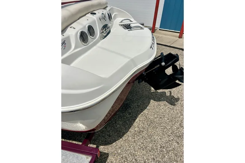 Slide: The Image of Rear view of a 2013 Tahoe Q4i boat on a trailer, showcasing the engine and seating area. - 17