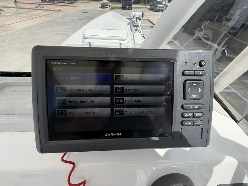 Slide: The Image of A Garmin fishfinder is mounted on a boat, surrounded by an open deck area. - 18
